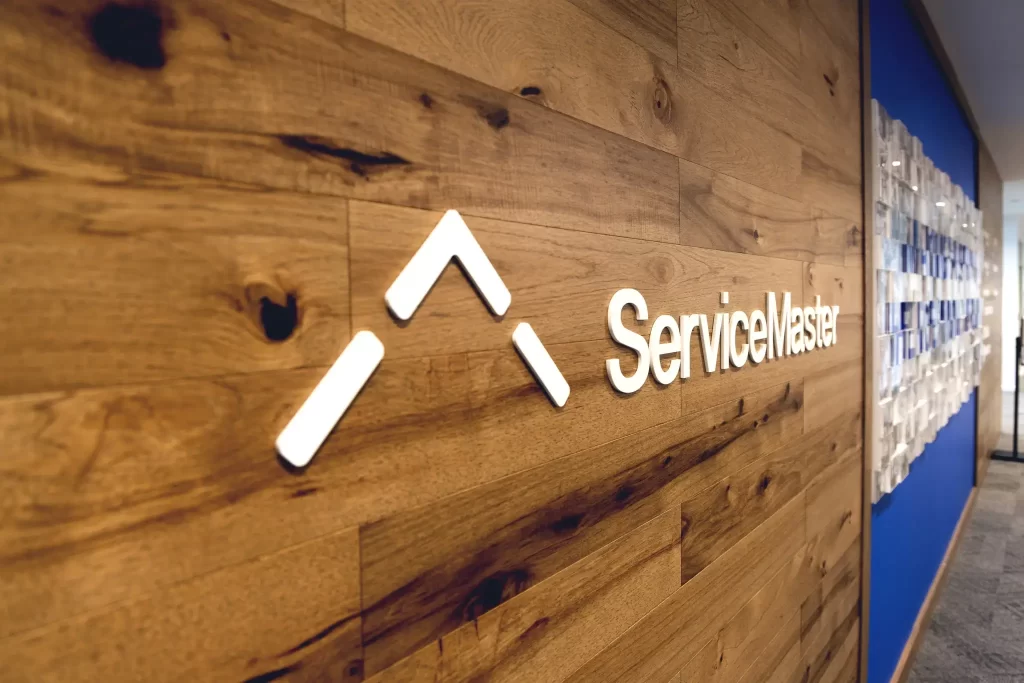 Dimensional wall signage for Service Master with custom logo and lettering on wood panel by 360CSG near College Park, GA.