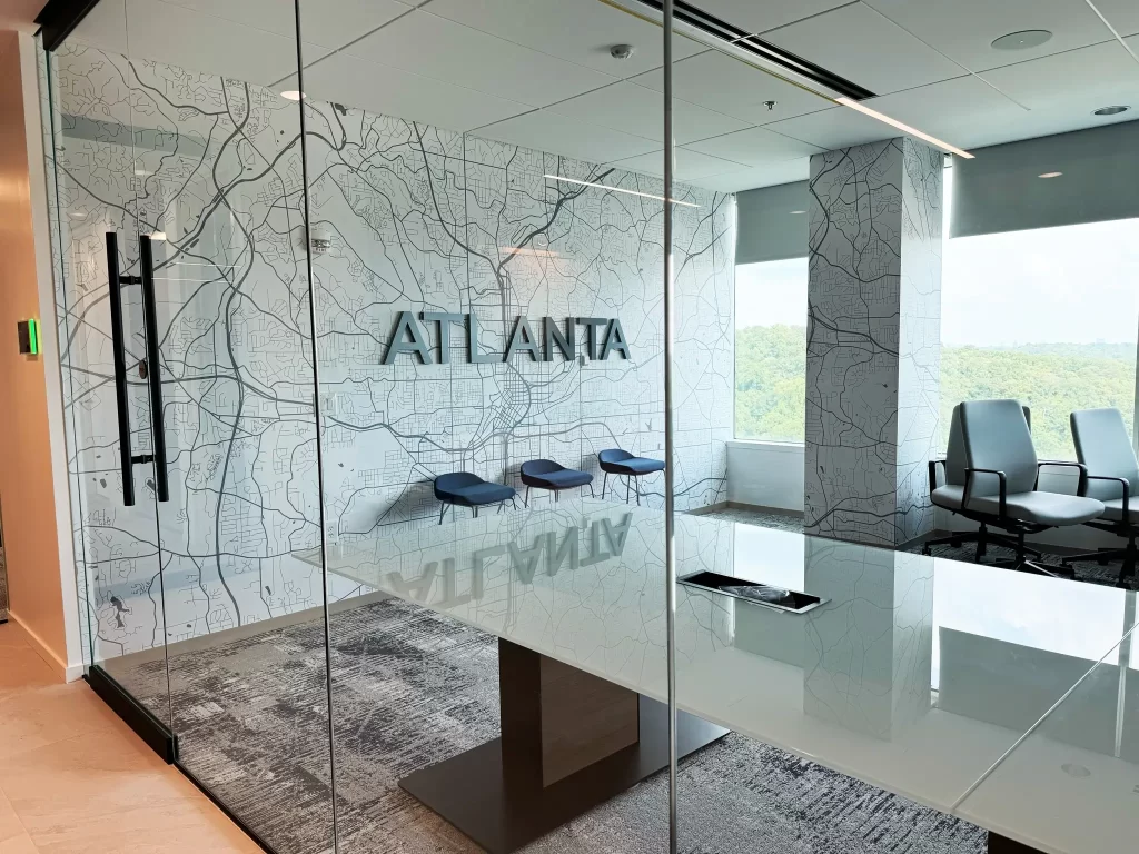 Interior branding by 360CSG showcasing custom dimensional Atlanta signage and Atlanta, Ga map wallpaper inside Ram Partners corporate meeting space